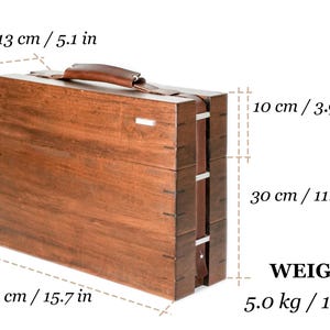 May include: A rectangular wooden carrying case with a brown leather handle, measuring 15.7 inches long, 5.1 inches wide, and 11.8 inches high, with a total weight of 11.0 lbs. The case features visible joinery and a small silver-toned metal accent.
