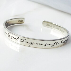 May include: Silver bangle bracelet with the inscription "only good things are going to happen".