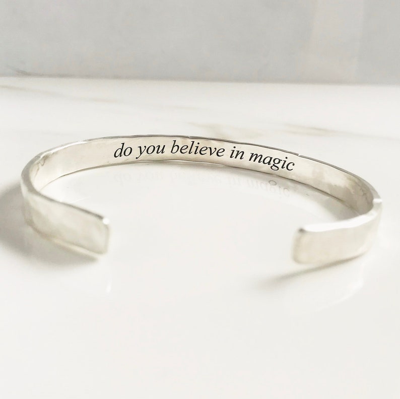 Puede incluir: Pulsera de plata con acabado martillado. El interior de la pulsera est&aacute; grabado con el texto "do you believe in magic".