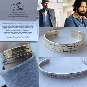 May include: Three silver bangle bracelets with engraved messages. The top bracelet reads "You are my Sunshine, My Only Sunshine". The middle bracelet reads "You are my Only Sunshine". The bottom bracelet reads "Only good things are going to happen today".