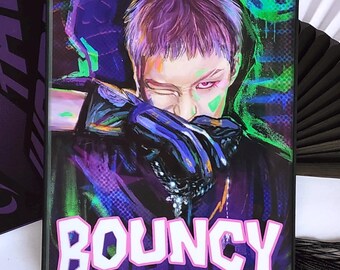 May include: A framed artwork featuring a stylized portrait of a person with purple hair and neon green accents. The word "BOUNCY" is prominently displayed in pink and white. A fan with text is visible in the background.