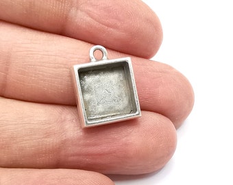 May include: Silver pendant with a square frame, perfect for adding a personal touch to jewelry projects.