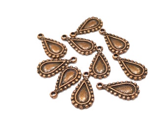 May include: Ten copper-colored teardrop-shaped metal charms with a beaded border. Each charm has a small loop at the top for attaching to jewelry or other crafts.