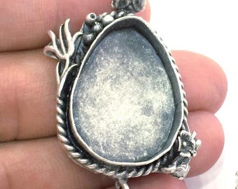 May include: Silver pendant with a dragon design and a round, empty bezel for a cameo or other embellishment.