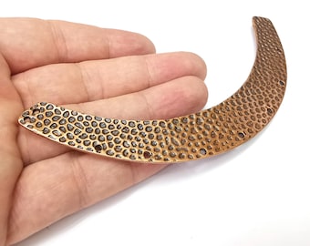 May include: A copper-colored metal connector with a textured surface and multiple holes. The connector is curved and has a rounded shape.