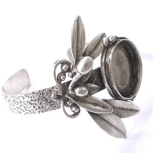 May include: Silver bracelet with an olive branch design and a round bezel for a cameo or other embellishment.