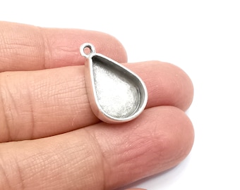 May include: Silver teardrop pendant with a smooth, rounded surface. The pendant has a loop at the top for attaching a chain or cord.