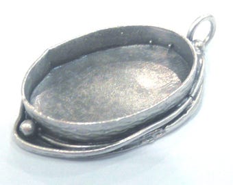 May include: Silver oval pendant setting with a textured rim and a loop for attaching a chain.