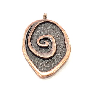 May include: A copper-colored pendant with a textured surface and a spiral design.