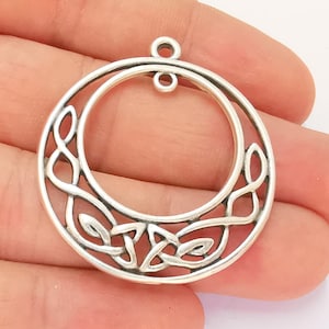 May include: Silver Celtic knot pendant with a circular design. The pendant has a loop at the top for attaching a chain.