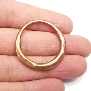 May include: A smooth, rounded copper ring with a slightly hammered finish.