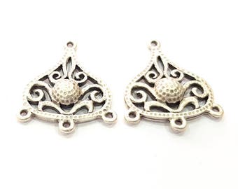 May include: Two silver filigree pendant charms with a textured round center and three loops at the bottom.