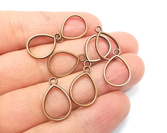 May include: A set of six antique gold-toned metal teardrop-shaped pendant blanks. The blanks have a smooth, polished finish and are ready for crafting.