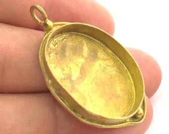 May include: Gold-toned oval pendant with a smooth, slightly textured surface. The pendant has a loop at the top for attaching a chain.