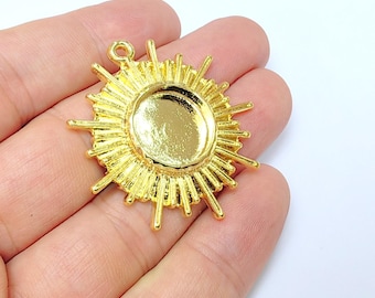 May include: Gold-toned metal sunburst pendant with a round, blank, flat center for adding a cameo or other embellishment.