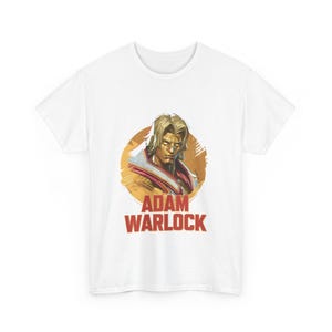May include: White t-shirt with a graphic of Adam Warlock from Marvel Comics. The graphic is a close-up of his face with a gold and red background. The text "Adam Warlock" is printed in red below the graphic.