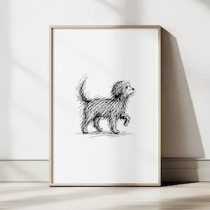 May include: A framed black and white sketch of a small dog with a fluffy coat, walking with one paw raised. The artwork is displayed on a white wall, leaning against a light-colored floor.