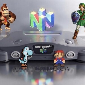May include: A gray Nintendo 64 video game console featuring a prominent N64 logo. The console is surrounded by figures of Donkey Kong, Link with a shield and sword, a pixelated light blue Yoshi, and a pixelated Mario, with Nintendo 64 text.
