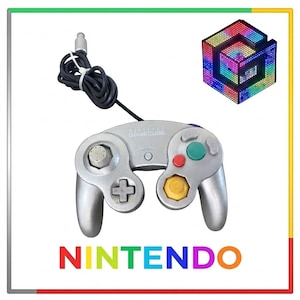 May include: A silver Nintendo GameCube controller with a black wired cable, featuring a central analog stick, a D-pad, a green A button, a red B button, a yellow C-stick, and a Start/Pause button. The word NINTENDO is printed in rainbow colors.