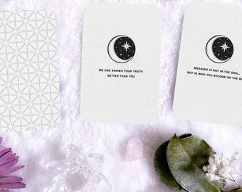 May include: Oracle cards with a celestial design and inspirational quotes. The cards feature a crescent moon and star motif. One card reads "No one knows your truth better than you." Another card reads "Meaning is not in the goal, but in who you become on the way."