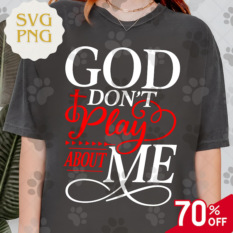 May include: Dark gray t-shirt with the text "GOD DON'T PLAY ABOUT ME" in white and red. The shirt has a round neckline and short sleeves. A 70% off sale tag is visible in the bottom right corner.