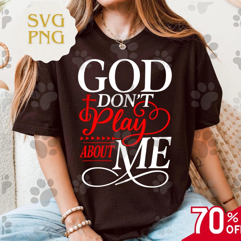 May include: A black t-shirt with the text "GOD DON'T PLAY ABOUT ME" in white and red. The shirt has a crew neck and short sleeves. The image also includes a "70% OFF" sale tag.