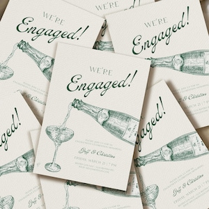 May include: Off-white engagement announcement cards with green text and illustrations. The cards feature the words "We're Engaged!" and a drawing of champagne being poured into a glass. The cards also include event details.