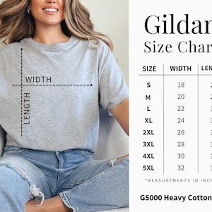 May include: A light grey Gildan G5000 heavy cotton tee shirt. The image includes a size chart with measurements in inches for sizes S to 5XL. The shirt is shown on a person wearing blue jeans.