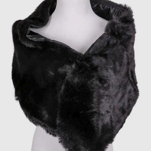 May include: A black faux fur shawl draped over a mannequin. The shawl has a V-neck design and a soft, textured appearance. The dark color and plush material suggest warmth and elegance, suitable for formal occasions.