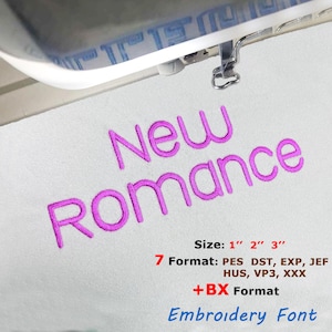 May include: An embroidery machine in action, creating the words "New Romance" in magenta thread on white fabric. The image includes size details of 2.5 cm, 5 cm, and 7.6 cm, along with format specifications for the embroidery font.