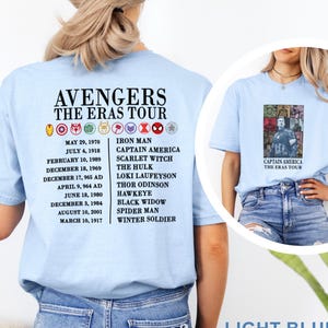 May include: Light blue t-shirts with "AVENGERS THE ERAS TOUR" text and character icons. The back lists dates and character names. The front has a Captain America graphic.