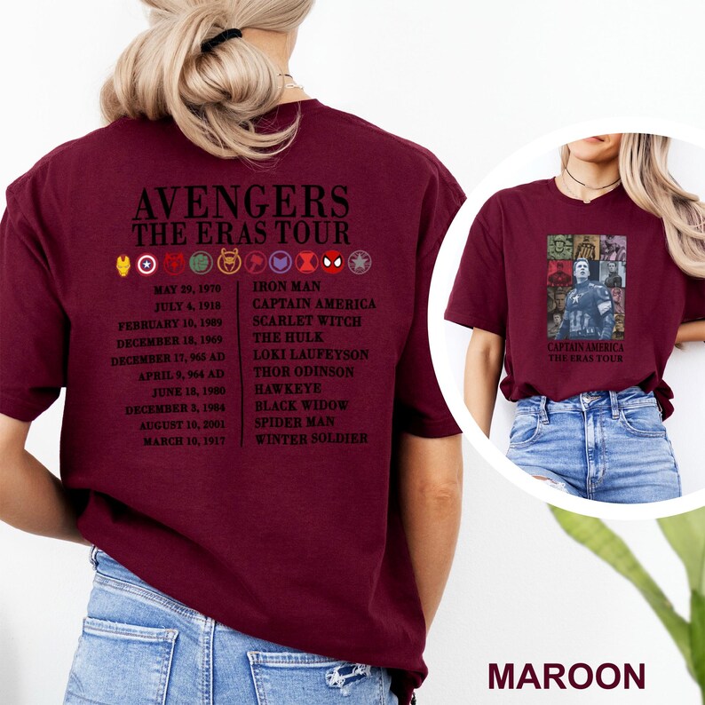 May include: Maroon t-shirt with "AVENGERS THE ERAS TOUR" text, character icons, and dates. The back lists characters such as Iron Man and Scarlet Witch. The front displays a Captain America graphic. The shirt is a deep red colour.