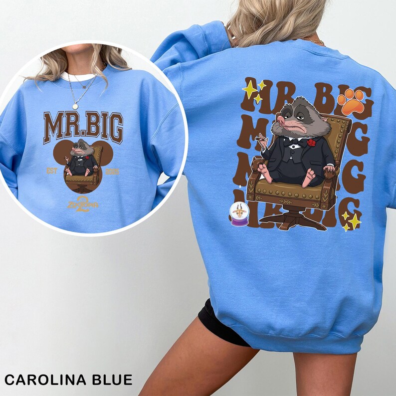May include: Carolina blue sweatshirt featuring a cartoon illustration of a character in a suit, seated in a chair. The front of the sweatshirt has the text "MR. BIG" in brown lettering. The back of the sweatshirt has the same character illustration and text.