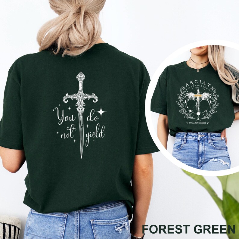May include: Forest green t-shirt with a white sword graphic and the text "You do not yield" on the back. Another shirt in the image has a circular design with text. The shirt is a casual wear item.