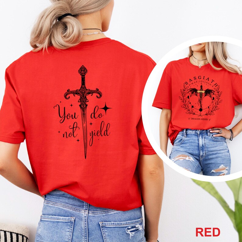 May include: Red t-shirts with black graphic designs. One shirt features a sword with the text "You do not yield." The other shirt has a circular design with the text "Basgiath War College" and "Dragon Rider V".