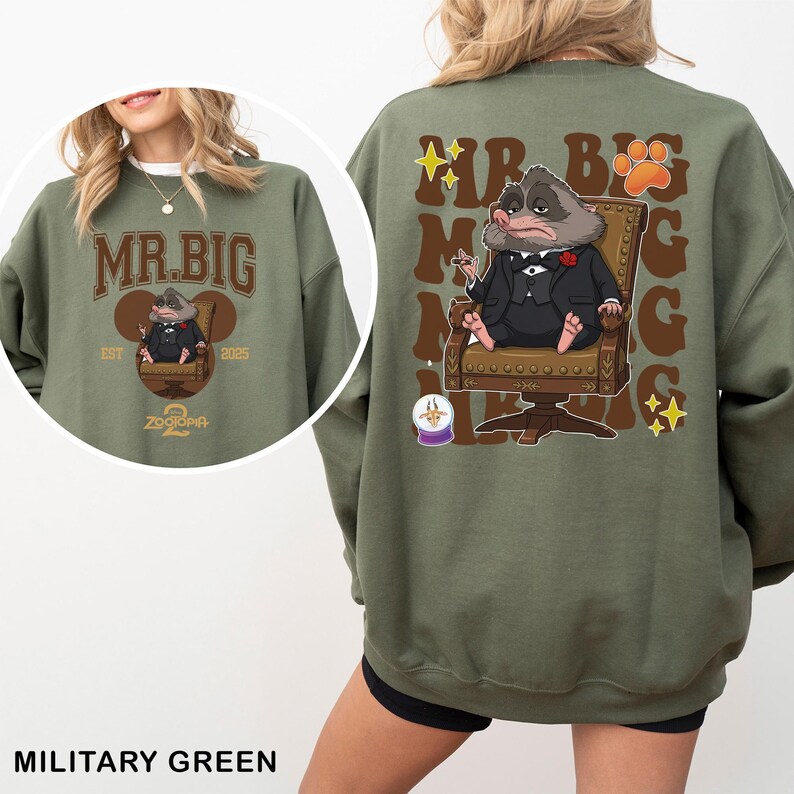 May include: Military green sweatshirt featuring a cartoon illustration of a rodent in a suit, seated in a chair. The front of the sweatshirt displays "MR. BIG" in brown lettering, with the text "EST 2025" and "Zootopia 2" below. The back has the same design.