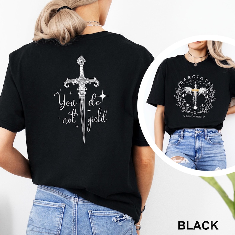 May include: Black t-shirt featuring a detailed silver sword design with the text "You do not yield". The shirt is a classic crew neck style. A second image shows a black t-shirt with a circular design and the text "Basgiath War College".