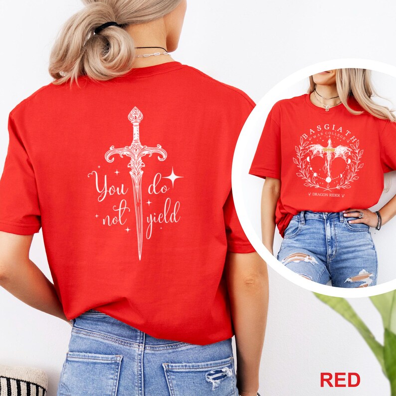 May include: Red t-shirts with white graphic designs. One shirt features a sword with the text "You do not yield." The other shirt has a circular design with text that reads "Basgiath War College" and "Dragon Rider".