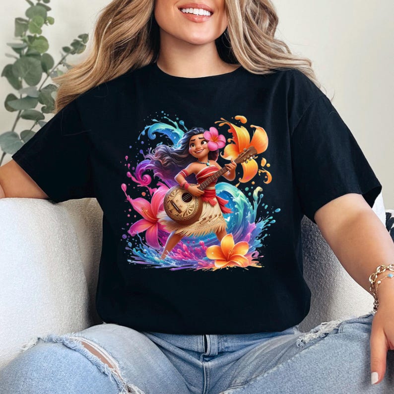 May include: Black t-shirt featuring a vibrant illustration of a woman playing a ukulele, surrounded by colorful flowers and water splashes. The design includes orange, pink, and blue hues, creating a tropical theme.
