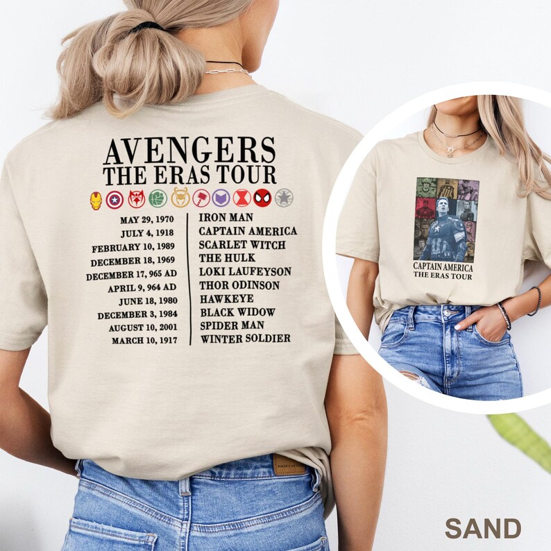 May include: A sand-coloured t-shirt with the text "AVENGERS THE ERAS TOUR" and character icons. The back of the shirt lists characters such as Iron Man and Captain America. A smaller image on the front shows Captain America.