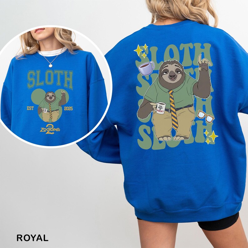 May include: Royal blue sweatshirt featuring a cartoon sloth character from Zootopia. The front design includes the word "SLOTH" above an image of the sloth holding a coffee cup. The back design repeats "SLOTH" with the sloth character, coffee cup, and glasses.