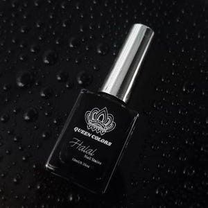 Puede incluir: Una botella de esmalte de uñas negro con una tapa plateada. La botella tiene una etiqueta blanca con el texto "Queen Colors Halal Nail Stains 10ml/0.35oz".