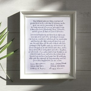 May include: A framed document with a handwritten wedding vow, signed by the bride and groom. The vow includes the date September 15, 2013, and the names Kimberly Jean Schneider and Edward Lubed Johnson.