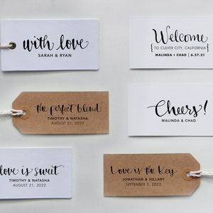 May include: Set of six wedding favor tags with different designs and text. The tags are white and brown with black calligraphy. The text includes "with love", "the perfect blend", "love is sweet", "Welcome", "Cheers!" and "Love is the key".