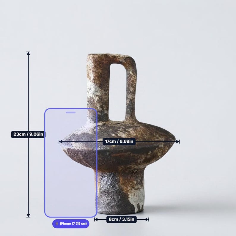 May include: A ceramic vase with a textured, mottled brown and black finish, featuring a central handle and a wide, rounded midsection. The vase measures 9.06 inches in height, 6.69 inches in width, and has a base diameter of 3.15 inches.