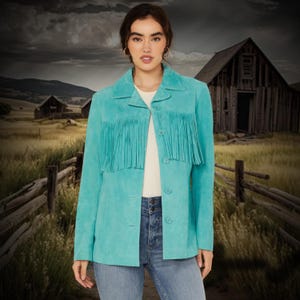 May include: A turquoise suede jacket with fringe detailing. The jacket has a button-up front and long sleeves.