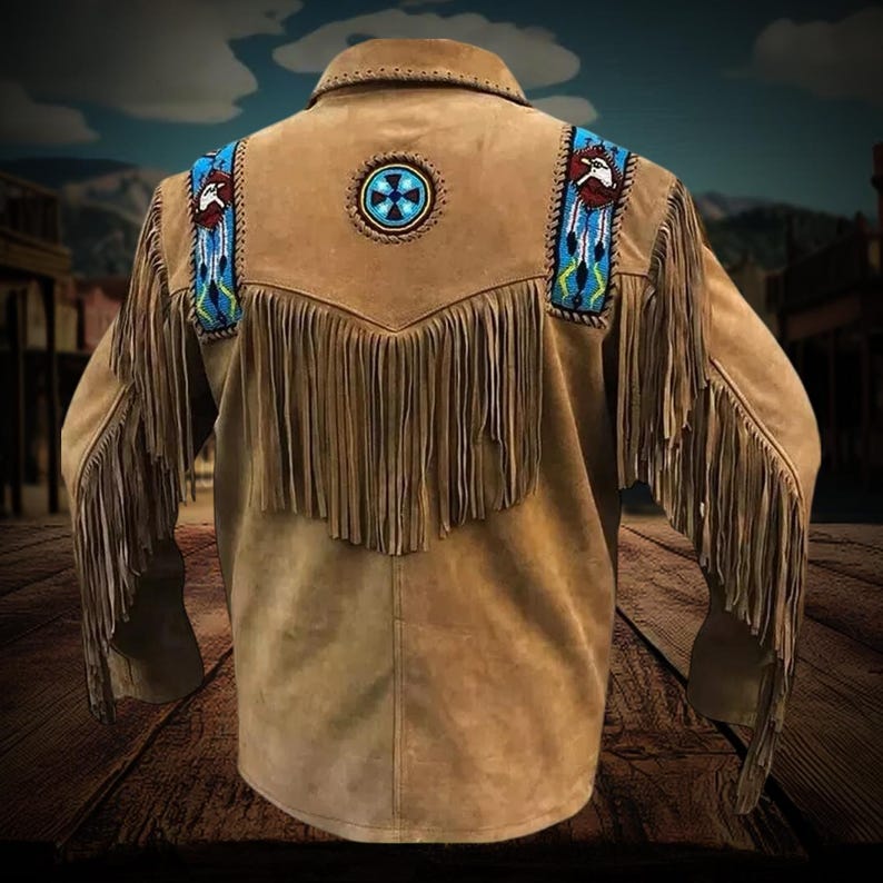 May include: A brown suede jacket with fringe detailing and beaded accents. The jacket has a Native American inspired design with a circular beaded emblem on the back.