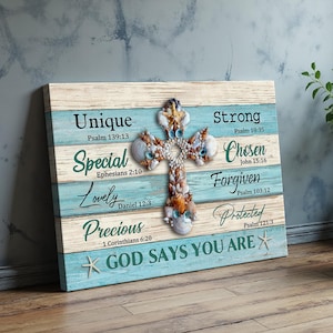 Peut inclure: Tableau mural en bois avec une croix faite de coquillages sur un fond rayé bleu clair et blanc. Le texte comprend "Unique", "Special", "Lovely", "Precious", "Strong", "Chosen", "Forgiven", "Protected" et "GOD SAYS YOU ARE".