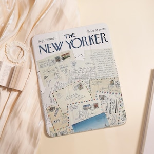 May include: A white tablet case with a vintage "The New Yorker" magazine cover design. The cover features the magazine's name, date, and price, plus a collage of old letters and stamps. The case is rectangular and has a smooth finish.