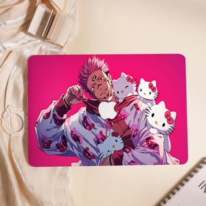 May include: A rectangular laptop skin featuring a vibrant pink background with an anime character with spiky pink hair and facial markings. The character wears a white hoodie patterned with small red shapes and is surrounded by three Hello Kitty figures.